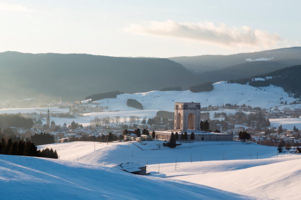 The memorial surrounded by the winter landscape.
