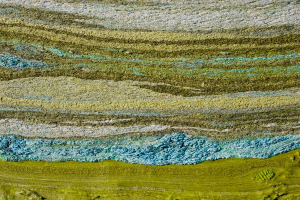 Thin layers of peat and silt capture the aesthetic nature of soil horizons in this artistic rendering.