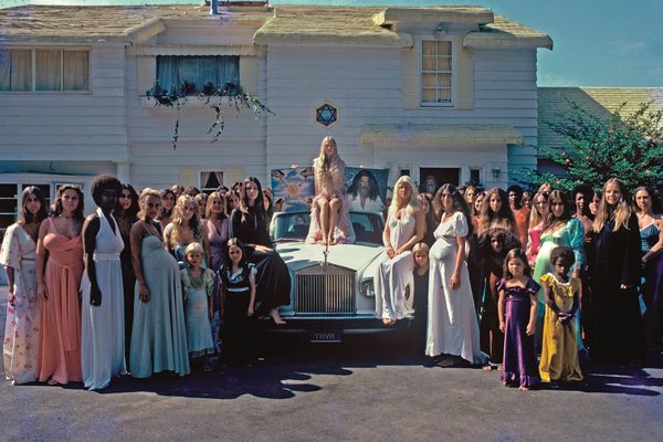 The women of the Source Family pose on a Rolls-Royce for an ad for the release of a recording of the cult’s band, Ya Ho Wha 13.