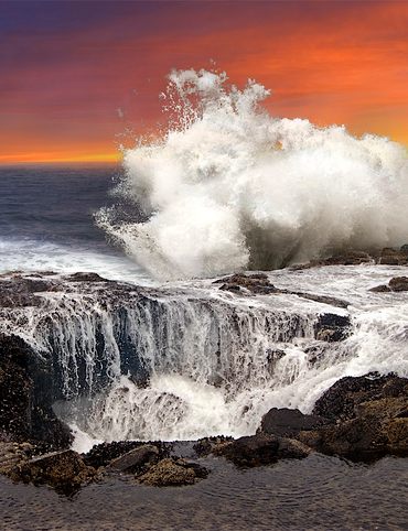 Waves crash against the rocks near Thor's Well in Oregon.