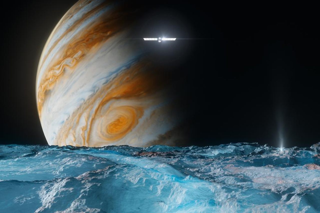 An artist's rendering of NASA's Europa Clipper passing over the ice-covered moon Europa as it orbits Jupiter. The spacecraft is scheduled to reach Jupiter in 2030.